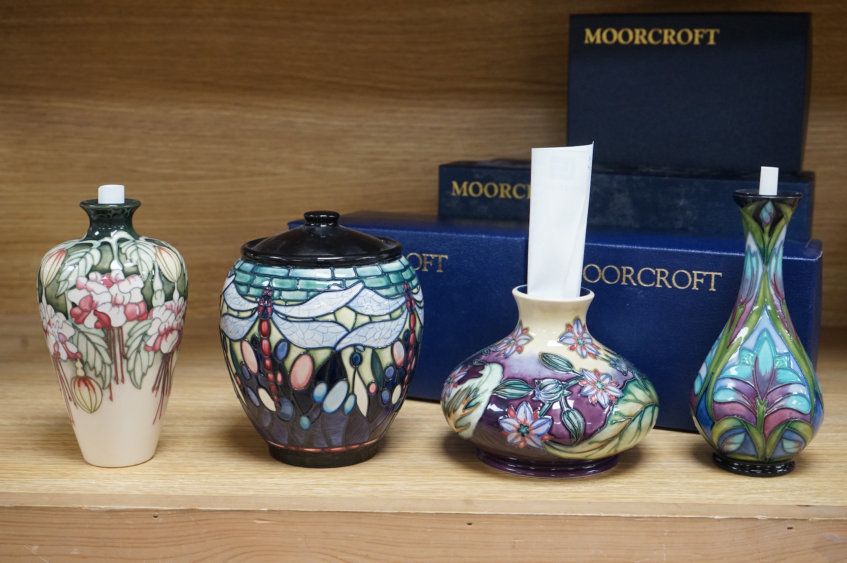 Four Moorcroft vases: Favrile Jar, Kerry vase, Cleopatra vase and a Borage vase. All boxed, tallest 17cm